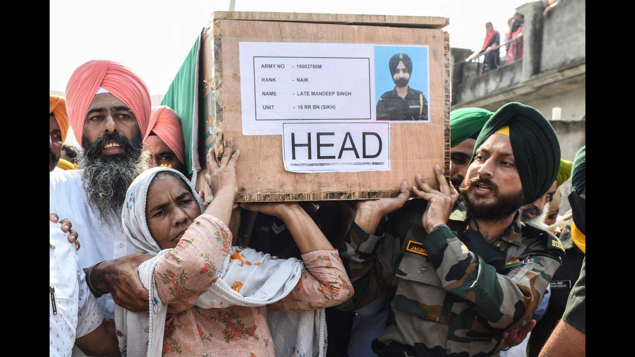 Mother (2L) and brother (R) of slain Indian Army soldier Mandeep Singh. Pic/AFP